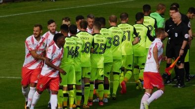 Hand shake between Stevenage and Exeter City players